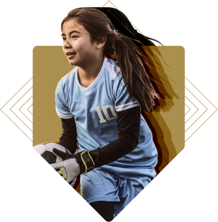 Youth girl goalkeeper wearing a soccer jersey handling a soccer ball